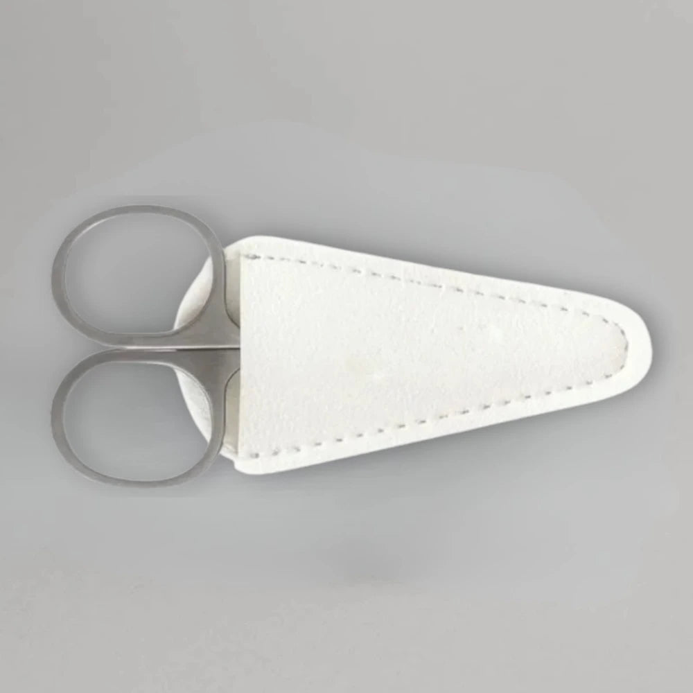 Scissors with a white sheath on a gray background