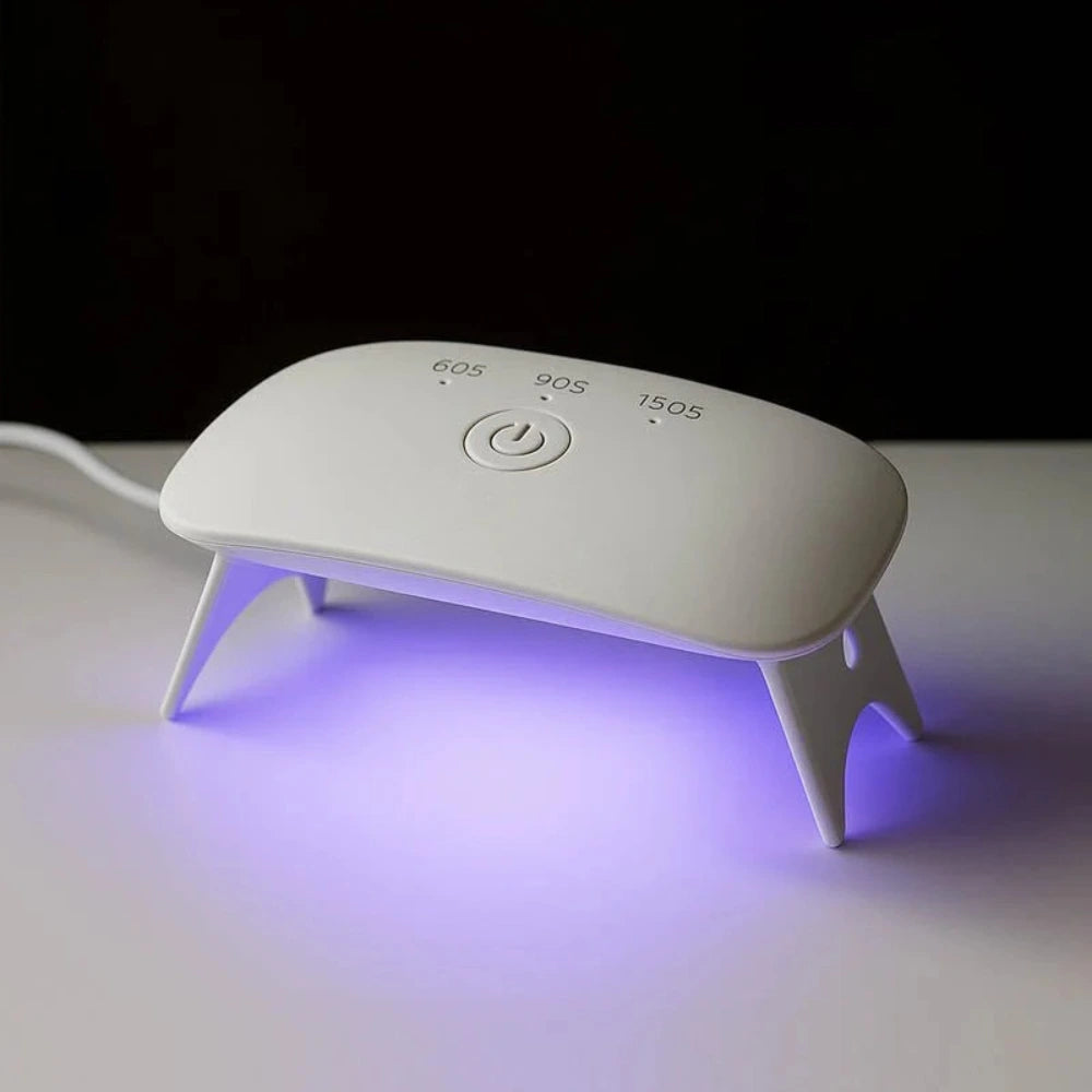 White nail dryer with a purple light on a white surface